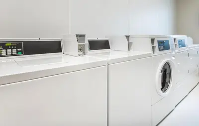 a white washing machine in a white laundry room at My Place Hotel-Marion, OH in Marion