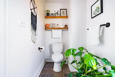 a bathroom with a toilet and a plant at Jungle House Luxury Homes - Columbus Downtown Short North - Steps to Convention Center & Nationwide Arena - Sleeps up to 11 - Free Parking - Over 5,800 Five Stars in Columbus