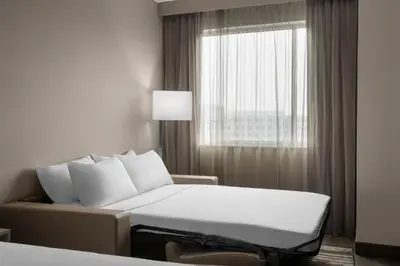 a hotel room with a bed and a window at AC Hotel by Marriott Pittsburgh Southpointe in Canonsburg