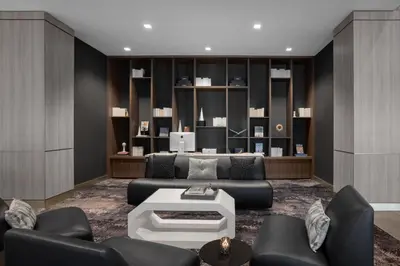 a living room with a couch and a table at AC Hotel by Marriott Pittsburgh Southpointe in Canonsburg