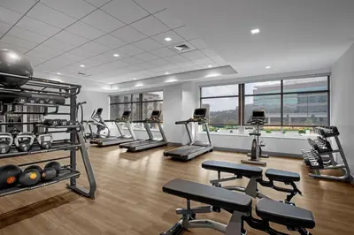 a gym with treadmills and elliptical machines at AC Hotel by Marriott Pittsburgh Southpointe in Canonsburg