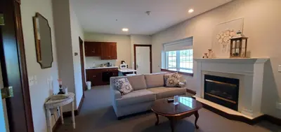 a living room with a couch and a fireplace at Inn at Amish Door in Wilmot