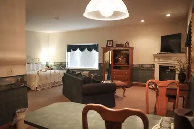 a living room with a couch and a white screen at Inn at Amish Door in Wilmot