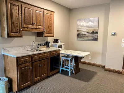 a kitchen with a counter with a sink and a microwave at Inn at Amish Door in Wilmot