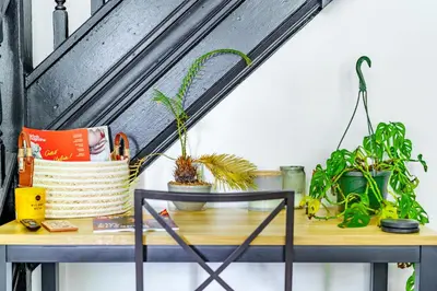 a table with plants on top of it at Jungle House Luxury Stays - Columbus Downtown Short North in Columbus