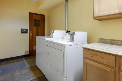 a laundry room with a washer and dryer in it at Days Inn by Wyndham Sandusky Cedar Point in Sandusky