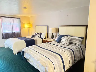 a hotel room with two beds and a window at St. Mary’s Motel in Saint Marys