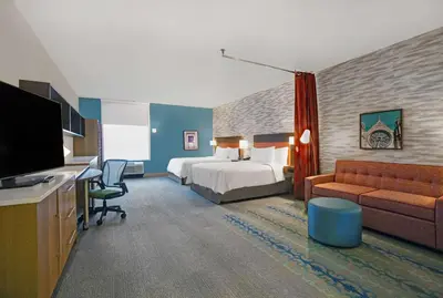 a hotel room with a bed and a couch at Home2 Suites By Hilton Richmond in Richmond