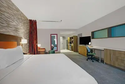 a hotel room with a large bed and a desk at Home2 Suites By Hilton Richmond in Richmond