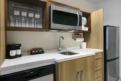 a small kitchen with a sink and a microwave at Home2 Suites By Hilton Richmond in Richmond