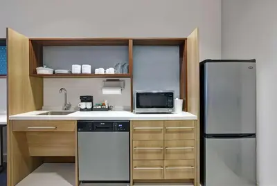 a kitchen with a refrigerator and a sink at Home2 Suites By Hilton Richmond in Richmond