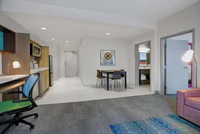 a living room with a table and a dining room at Home2 Suites By Hilton Richmond in Richmond