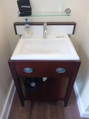a bathroom vanity with a sink and a mirror at Lee House Inn in Maysville
