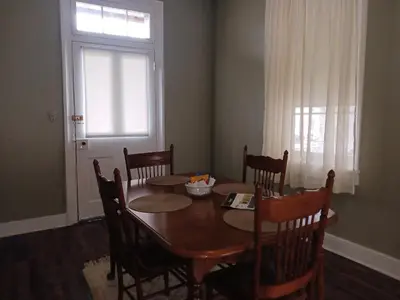 a dining room with a table and chairs and a window at Lee House Inn in Maysville