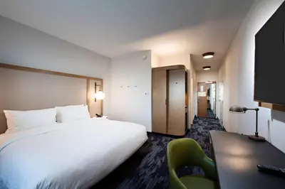 a hotel room with a large white bed and a desk at Fairfield Inn & Suites by Marriott Dayton North in Murlin Heights