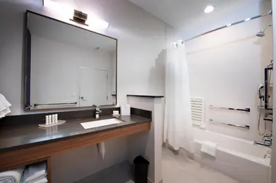 a bathroom with a sink and a large mirror at Fairfield Inn & Suites by Marriott Dayton North in Murlin Heights