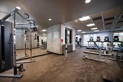 a gym with several treadmills and elliptical machines at Fairfield Inn & Suites by Marriott Dayton North in Murlin Heights