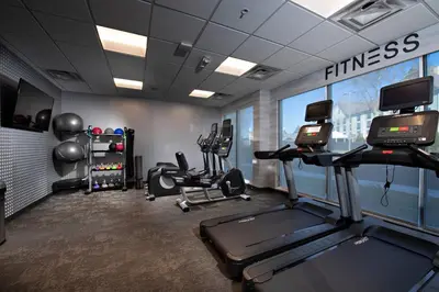 a gym with treadmills and ellipticals in a room at Fairfield Inn & Suites by Marriott Dayton North in Murlin Heights
