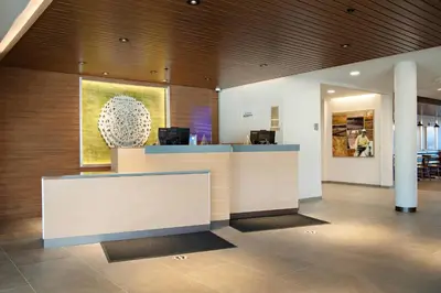 a lobby with a reception desk in a building at Fairfield Inn & Suites by Marriott Dayton North in Murlin Heights
