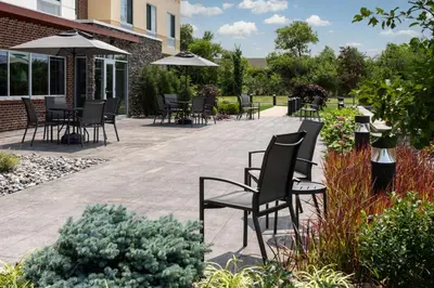 a patio with chairs and tables and umbrellas at Fairfield Inn & Suites by Marriott Cleveland Tiedeman Road in Brooklyn