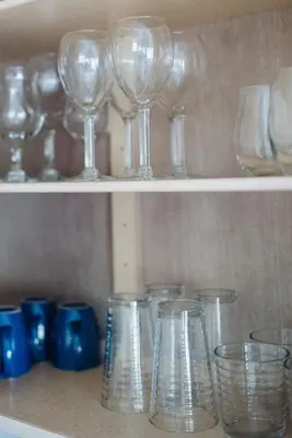 a row of wine glasses sitting on a shelf at Chapman House in Put-in-Bay