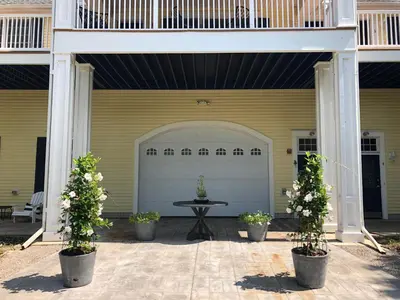 a garage with a table and two potted plants at Chapman House in Put-in-Bay