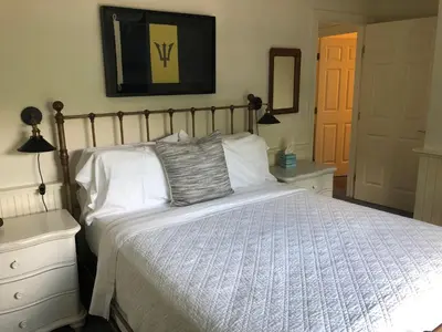 a bedroom with a large bed with white pillows at Chapman House in Put-in-Bay