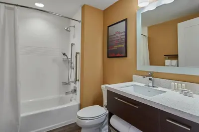 a bathroom with a sink and a tub and a toilet at TownePlace Suites by Marriott Columbus North - OSU in Columbus