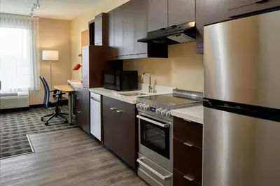 a kitchen with stainless steel appliances and a desk at TownePlace Suites by Marriott Columbus North - OSU in Columbus