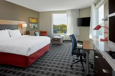 a hotel room with a bed and a desk at TownePlace Suites by Marriott Columbus North - OSU in Columbus