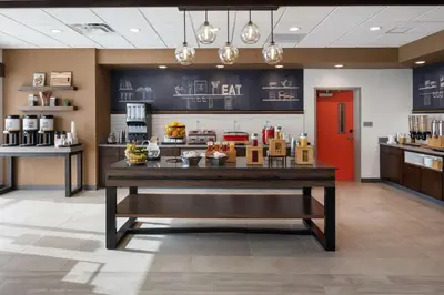 a cafeteria with a table with food on it at Hampton Inn Circleville, Oh in Circleville