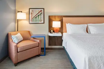 a hotel room with a bed and a chair at Hampton Inn Circleville, Oh in Circleville