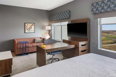 a hotel room with a desk and a tv at Hampton Inn Circleville, Oh in Circleville