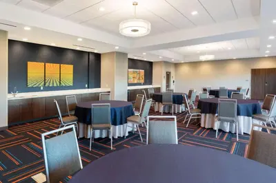 a conference room with tables and chairs and a large screen at Hampton Inn Circleville, Oh in Circleville