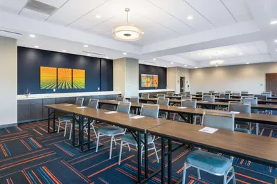 a classroom with tables and chairs and a large screen at Hampton Inn Circleville, Oh in Circleville