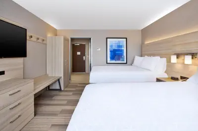 a hotel room with two beds and a flat screen tv at Holiday Inn Express & Suites Wooster by IHG in Wooster