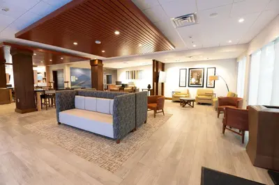 a lobby with a waiting room with a couch and chairs at Holiday Inn Express & Suites Dayton East - Beavercreek by IHG in Beavercreek