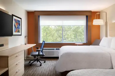 a hotel room with a bed and a desk and a window at Holiday Inn Express & Suites Dayton East - Beavercreek by IHG in Beavercreek