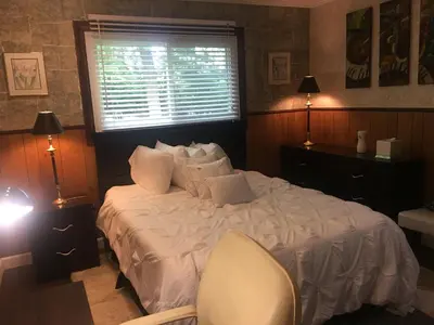 a bedroom with a bed with a window and a chair at Home Sweet Home in Solon