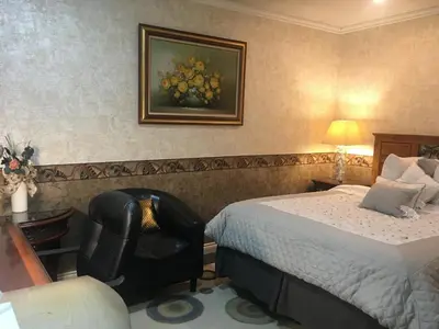 a hotel room with a bed and a chair at Home Sweet Home in Solon