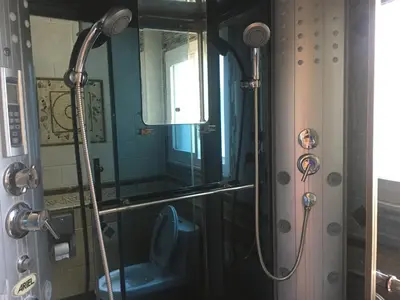 a bathroom with a shower with a toilet and a mirror at Home Sweet Home in Solon