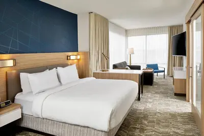 a hotel room with a bed and a living room at SpringHill Suites by Marriott Columbus Dublin in Dublin