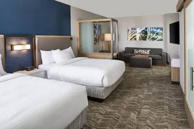 a hotel room with two beds and a couch at SpringHill Suites by Marriott Columbus Dublin in Dublin