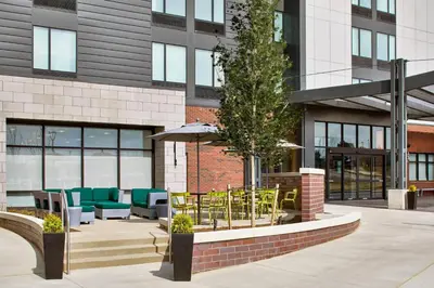 a patio with tables and chairs in front of a building at SpringHill Suites by Marriott Columbus Dublin in Dublin