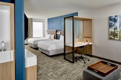 a hotel room with two beds and a desk at SpringHill Suites by Marriott Columbus Dublin in Dublin