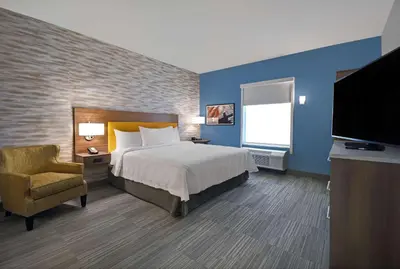 a hotel room with a bed and a television at Home2 Suites By Hilton Springdale Cincinnati in Springdale