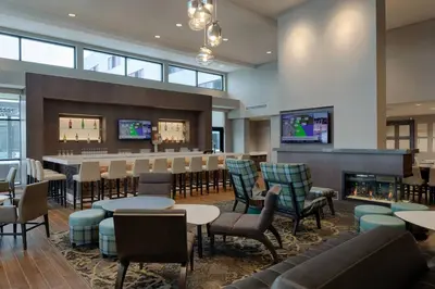 a lobby with a bar and tables and chairs at Residence Inn by Marriott Columbus Airport in Columbus