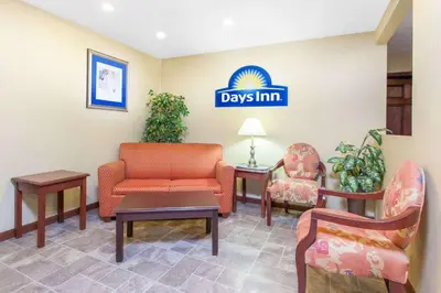 a waiting room with chairs and a sign for days inn at Days Inn by Wyndham Maumee/Toledo in Maumee