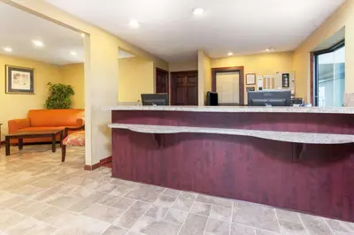 a hotel lobby with a reception counter and a waiting room at Days Inn by Wyndham Maumee/Toledo in Maumee