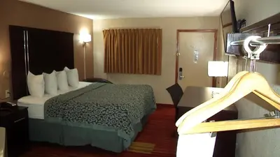 a hotel room with a bed and a bathroom at Days Inn by Wyndham Maumee/Toledo in Maumee